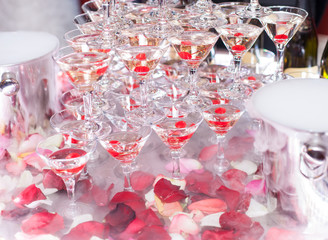 Champagne in glasses with fresh cherry on table - party background