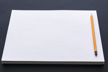 black and white workplace of a paper pile with pen