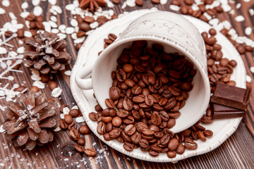 Coffee cup and  beans on wooden background.