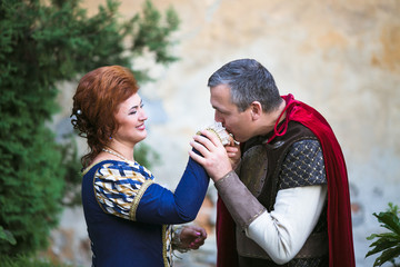 Beautiful couple in medieval dress posing in old city