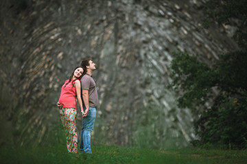 Beautiful pregnant woman with her husband posing outside