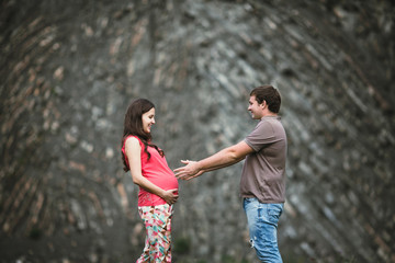 Fototapeta premium Beautiful pregnant woman with her husband posing outside