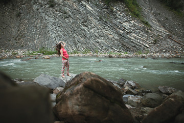 Beautiful pregnant woman posing near the river