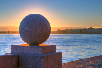 Spit of Vasilyevsky Island and Neva River at dawn with granite ball in front of sunrise, Saint Petersburg, Russia.