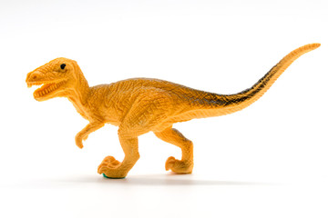 Velociraptor toy model on white background © Noey smiley