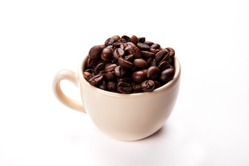 Coffee beans in coffee cup isolated on white