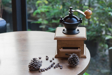 wooden traditional coffee maker with coffee seed on wooden table in coffee shop on natural view at relax coffee time / coffee maker and coffee seed