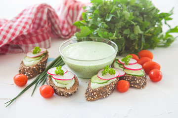 green vegetable cheese and sandwiches on a table, selective focus