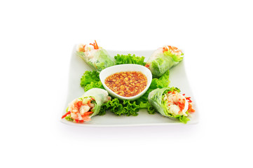 Raw spring rolls with shrimp in white plate isolated