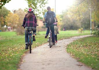 Naklejka premium Happy family on bikes, cycling with kids