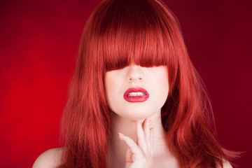 Woman with red wig on red background