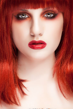 Woman with red wig and pale doll tape skin