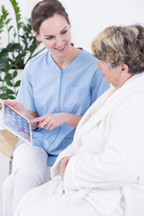 Fototapeta premium Nurse pointing something on a tablet