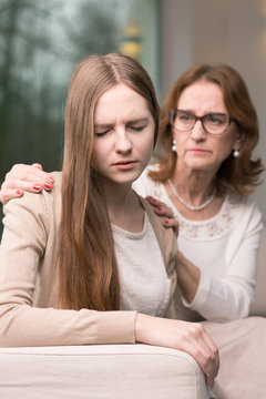 Woman supporting her sad daughter