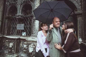 Father and his daughters posing in the old town