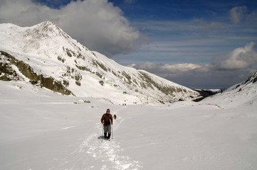 Naklejka na ściany i meble People hiking in beautiful winter mountains