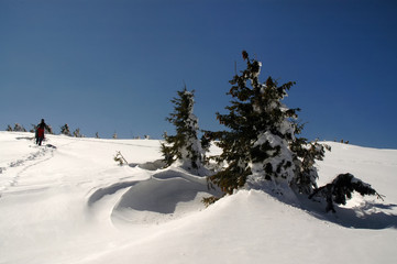 People hiking in beautiful winter mountains