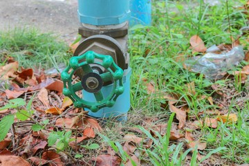 Water valve Plumbing Steel on grass. industrial tap water pipe.