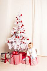 Obraz na płótnie Canvas Portrait of a little boy at home near the Christmas tree.