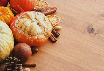 Seasonal wooden table setting with small pumpkins