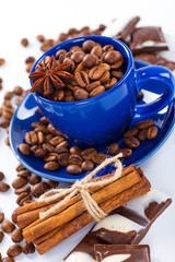 Cup of coffee and beans with delicious macaroon on a white backg