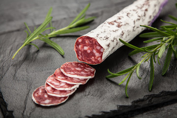 Salami on dark background