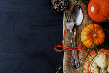 Seasonal wooden table setting with small pumpkins