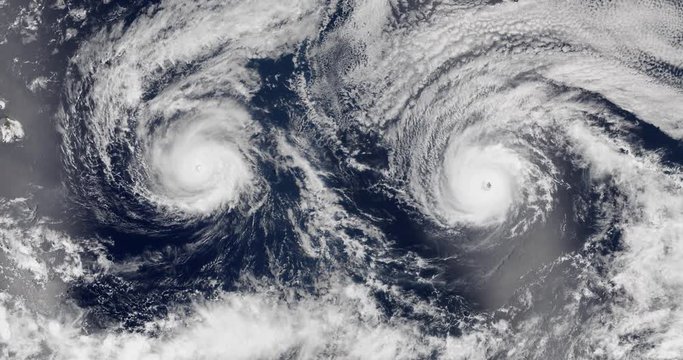 View from orbit of side-by-side Hurricanes Lester and Madeline, in late summer 2016. Elements of this image furnished by NASA.