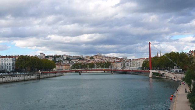Timelipse view of Lyon city France Saone river, vaporeto and red bridge by day, 4k timelapse