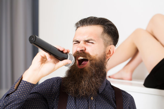 bearded man singing and woman
