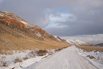 Winter rural road along the hill