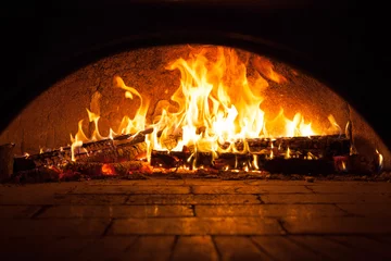 Foto op Plexiglas Image of a brick pizza oven with fire © Polthanawat