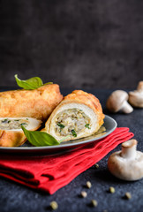 Fried rolls coated in batter and stuffed with mushroom, cheese, onion and parsley   