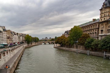 Obraz premium PARIS, FRANCE, circa april 2016. Partial view of the Saint Michel bridge from the quai Saint Michel, on the right the Police Prefecture of Paris