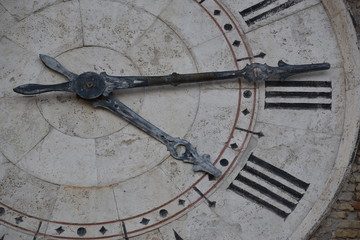 Clock tower partial view over hands and roman numbers, San Benedetto del Tronto, Italy