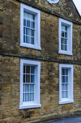 Traditional house in UK - stone structure with white framed windows