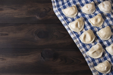 Traditional polish dumplings, pierogi on wooden table. Image with copy space.