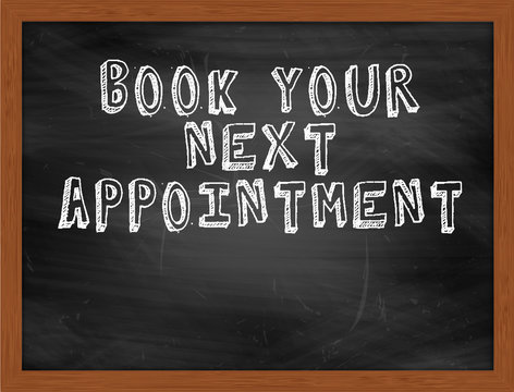 BOOK YOUR NEXT APPOINTMENT handwritten text on black chalkboard