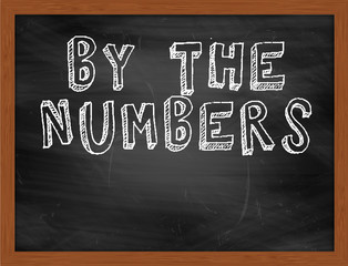 BY THE NUMBERS handwritten text on black chalkboard