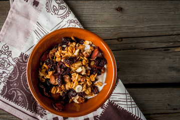 The cozy breakfast, Homemade granola with dried fruits and nuts, organic yogurt in jar. 