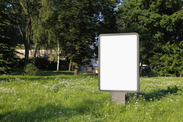 Blank billboard in a park, green environment