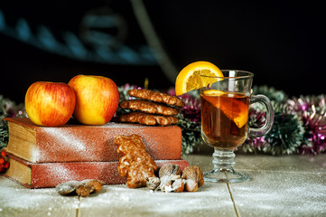 Mulled wine for Christmas with orange apples on dark background