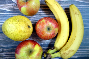 Various fruits on wooden board background, healthy nutrition 
