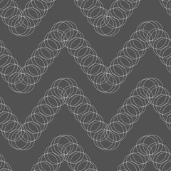 Seamless pattern of circles on a dark background.