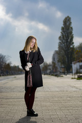 Young woman enjoying an autumn day in the park