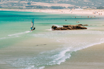 People resting at beach in Tarifa, Spain.