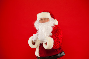 Santa Claus is preparing for fight. red background.