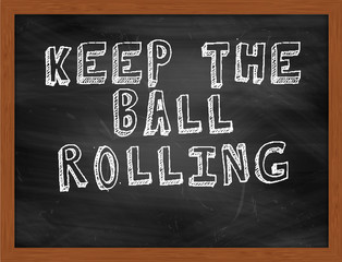 KEEP THE BALL ROLLING handwritten text on black chalkboard © Ionut  Catalin Parvu