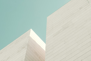 Abstract architecture. Detail of a building facade made of stone blocks - obrazy, fototapety, plakaty