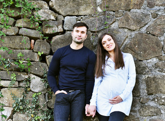 Obraz na płótnie Canvas Happy and young pregnant couple